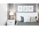 Cozy bedroom with a decorative headboard, soft pillows, and a modern lamp on the nightstand at 2916 Simile St, Kissimmee, FL 34746