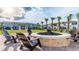 Inviting outdoor fire pit with seating, perfect for relaxing evenings in a lush community setting at 2916 Simile St, Kissimmee, FL 34746