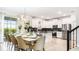 Open-concept kitchen with stainless steel appliances, black backsplash, and a dining area set for a meal at 2916 Simile St, Kissimmee, FL 34746