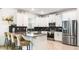 Modern kitchen with stainless steel appliances, gray countertops, and a convenient breakfast bar seating area at 2916 Simile St, Kissimmee, FL 34746