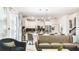 Bright and airy living space connecting to a modern kitchen with stainless steel appliances and bar seating at 2916 Simile St, Kissimmee, FL 34746