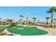 Fun mini golf green with beautiful tiki hut and landscaping, perfect for enjoying the Florida sunshine at 2916 Simile St, Kissimmee, FL 34746