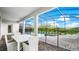 Screened-in patio with a table and chairs next to the pool and spa at 2916 Simile St, Kissimmee, FL 34746