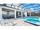 View of the pool and spa featuring outdoor seating and a screened enclosure at 2916 Simile St, Kissimmee, FL 34746