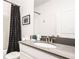 Well-lit bathroom with a single sink vanity and shower featuring a stylish curtain at 2936 Protagonist St, Kissimmee, FL 34746