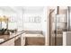 Elegant bathroom featuring double sinks, a soaking tub, and a glass-enclosed shower at 2936 Protagonist St, Kissimmee, FL 34746