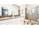 Modern bathroom featuring double sinks, a walk-in shower, and contemporary finishes at 2936 Protagonist St, Kissimmee, FL 34746