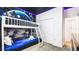 This themed bedroom features a bunk bed and an accent wall with Star Wars decor at 2936 Protagonist St, Kissimmee, FL 34746