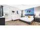 This primary bedroom features a king bed, a crib, modern decor, and lots of light at 2936 Protagonist St, Kissimmee, FL 34746