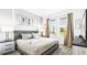 Neutral bedroom featuring a gray bed frame, patterned bedding, and bright natural light at 2936 Protagonist St, Kissimmee, FL 34746