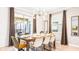 Open dining area with modern chandelier, seating for six, and sliding glass doors at 2936 Protagonist St, Kissimmee, FL 34746