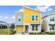 Modern two-story home features a bright yellow accent wall and attached garage at 2936 Protagonist St, Kissimmee, FL 34746