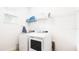 Functional laundry room with a washer, dryer, storage shelves, and natural light at 2936 Protagonist St, Kissimmee, FL 34746