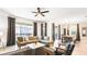 Spacious living area connecting to the dining room, with an L-shaped sofa and sliding glass doors at 2936 Protagonist St, Kissimmee, FL 34746