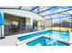 Sparkling screened-in pool and spa featuring a -safe fence, and outdoor lounging at 2936 Protagonist St, Kissimmee, FL 34746