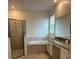 Bathroom featuring a glass shower, soaking tub, and vanity with sink at 3084 Ella Way, St Cloud, FL 34771