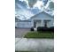 Charming home featuring a two-car garage, stone accents, and well-maintained landscaping at 3084 Ella Way, St Cloud, FL 34771