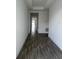 Modern hallway showcasing sleek, dark wood-look tile floors and neutral paint at 3084 Ella Way, St Cloud, FL 34771