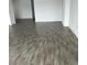 Minimalist living room featuring wood-style tile flooring and neutral walls at 3084 Ella Way, St Cloud, FL 34771