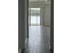 Open floorplan with modern tile floors, a lake view, and sliding glass doors to the lanai at 3084 Ella Way, St Cloud, FL 34771