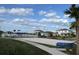 Community sand volleyball court and playground surrounded by homes under a partly cloudy sky at 3084 Ella Way, St Cloud, FL 34771