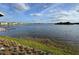 Expansive water view with dock and neighborhood in the background under a partly cloudy sky at 3084 Ella Way, St Cloud, FL 34771