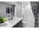 Modern bathroom with sleek fixtures, a white vanity, a soaking tub and stylish grey and white curtains at 3173 Douglas Fir Dr, Apopka, FL 32703