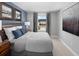 Cozy bedroom with a queen bed, blue accent wall, and neutral decor at 3173 Douglas Fir Dr, Apopka, FL 32703