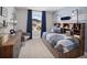 Bright bedroom with modern decor, built-in shelving, and a view to the outdoors through a large window at 3173 Douglas Fir Dr, Apopka, FL 32703
