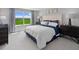 Serene main bedroom with a large window, plush bedding, and elegant decor at 3173 Douglas Fir Dr, Apopka, FL 32703