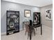 A stylish home office features modern shelving, a sleek black desk, and neutral decor for a professional workspace at 3173 Douglas Fir Dr, Apopka, FL 32703