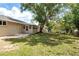 The large backyard features mature trees, offering lots of shade and privacy at 326 Evergreen Ct, Apopka, FL 32712