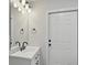 The bathroom features sleek fixtures, modern vanity and lighting, and an elegant white door at 326 Evergreen Ct, Apopka, FL 32712