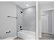 Modern bathroom showcasing a tiled shower-tub combo with sleek black fixtures and hardware at 326 Evergreen Ct, Apopka, FL 32712