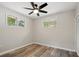 This bedroom features two windows, stylish flooring and a contemporary ceiling fan with light at 326 Evergreen Ct, Apopka, FL 32712