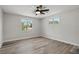This bedroom features two windows, stylish flooring and a contemporary ceiling fan with light at 326 Evergreen Ct, Apopka, FL 32712