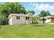 Single-story home with a well-manicured lawn, attached garage, and welcoming front porch at 326 Evergreen Ct, Apopka, FL 32712