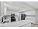 Modern kitchen featuring white cabinets, stainless steel appliances, and stone backsplash at 326 Evergreen Ct, Apopka, FL 32712