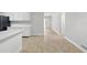 Bright kitchen showcasing modern white cabinetry and stainless steel appliances at 326 Evergreen Ct, Apopka, FL 32712