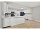 Open kitchen with white cabinetry, stainless steel appliances, and a functional island at 326 Evergreen Ct, Apopka, FL 32712