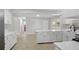 Open kitchen layout with white cabinets, modern appliances, and an island at 326 Evergreen Ct, Apopka, FL 32712