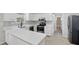 Charming kitchen featuring white cabinets, quartz countertops, and stainless steel appliances at 326 Evergreen Ct, Apopka, FL 32712
