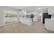 Well-lit kitchen featuring white cabinetry, an island, and views of the screened patio at 326 Evergreen Ct, Apopka, FL 32712