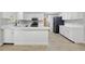 Well-lit kitchen with an expansive island, stainless steel appliances, and white cabinets at 326 Evergreen Ct, Apopka, FL 32712