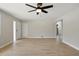 Open-concept living room boasts tile floors, a ceiling fan, and great natural light at 326 Evergreen Ct, Apopka, FL 32712