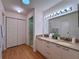 Bathroom featuring double sinks, granite countertops, and ample storage at 32900 Crooked Oaks Ln, Leesburg, FL 34748