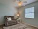 Bedroom with chair, lamp, and window at 32900 Crooked Oaks Ln, Leesburg, FL 34748
