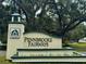 Pennbrooke Fairways entrance sign surrounded by lush greenery and mature trees at 32900 Crooked Oaks Ln, Leesburg, FL 34748