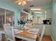 Inviting eat-in kitchen features a wood table, lovely table setting, and a view of the spacious kitchen at 32900 Crooked Oaks Ln, Leesburg, FL 34748