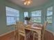 Bright dining area filled with natural light, featuring a traditional table and chairs, perfect for Gathering meals at 32900 Crooked Oaks Ln, Leesburg, FL 34748